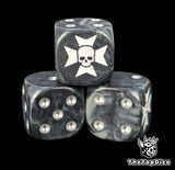 Close up of a black 16mm resin D6 die engraved with a white cross over a skull