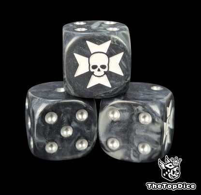 Close up of a black 16mm resin D6 die engraved with a white cross over a skull