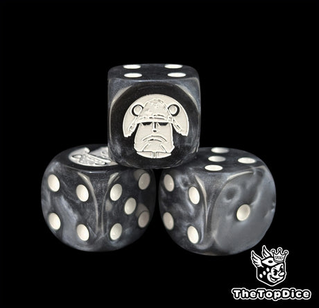 Close up of a black 16mm resin D6 die engraved with a white cyborg emblem and white pips