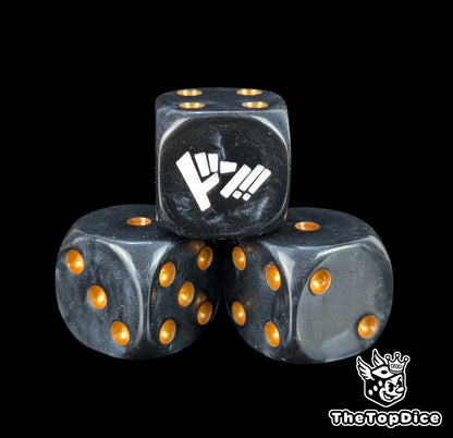 Close up of a black 16mm resin D6 die engraved with gold pips as a TCG power counter