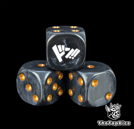 Close up of a black 16mm resin D6 die engraved with gold pips as a TCG power counter