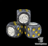 Close up of a black 16mm resin D6 die engraved with a white cook emblem and yellow pips