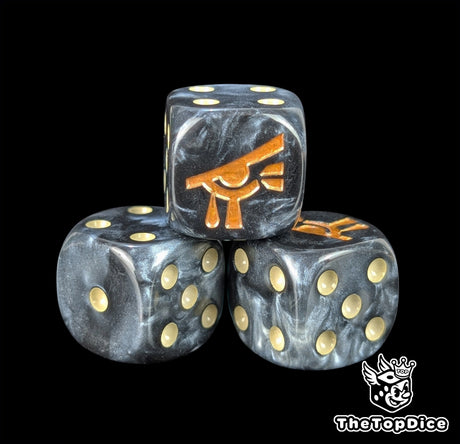 Close up of a black and grey 16mm resin D6 die engraved with a gold eye and beige pips