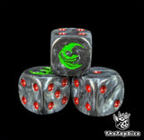 Close up of a black 16mm resin D6 die engraved with a green grinning moon and red pips