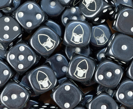 A pile of black Ulthwe Eldar dice with bone pips and pale seer helms
