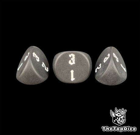 Sharp engraving on matte black 16mm three sided dice, seen close