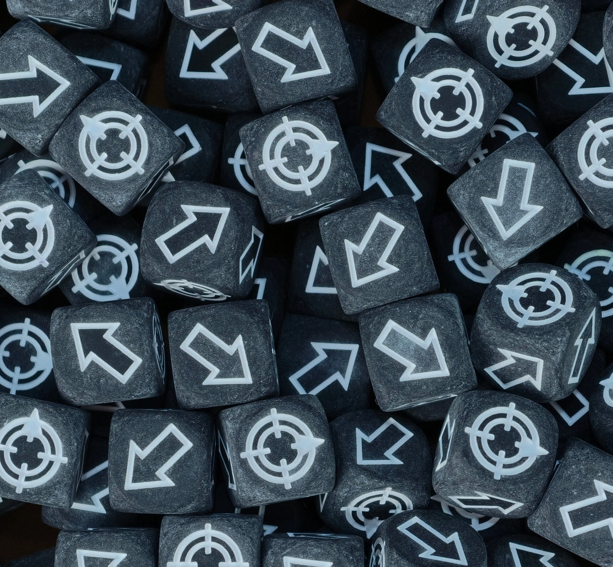 Matte black and white scatter dice filling a tray for cannons and catapults