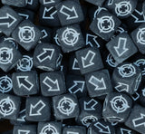 Matte black and white scatter dice filling a tray for cannons and catapults