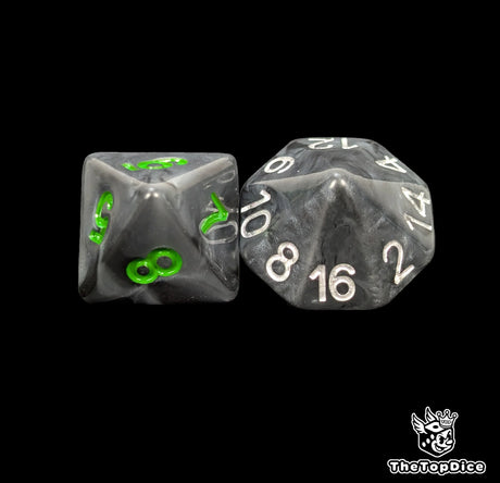 Close up of a black orc D8 and D16 with green numbers for scatter and long range rolls