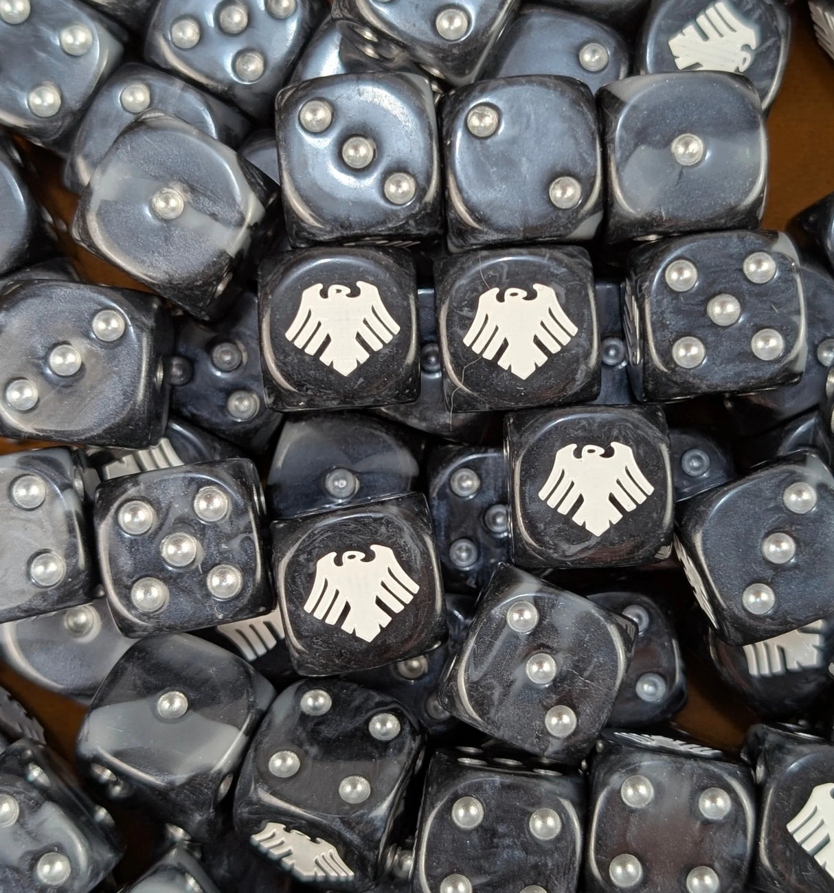 Pile of black and grey raven 16mm D6 dice for a sci-fi stealth army