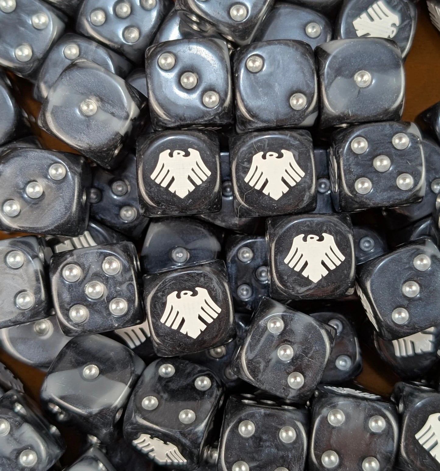 Pile of black and grey raven 16mm D6 dice for a sci-fi stealth army