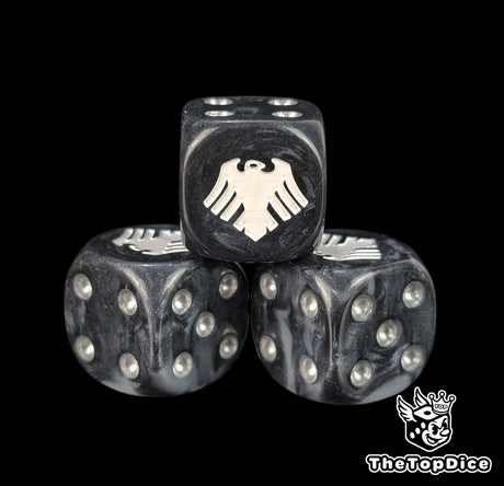 Close up of a black and grey 16mm resin D6 die engraved with a white raven and silver pips