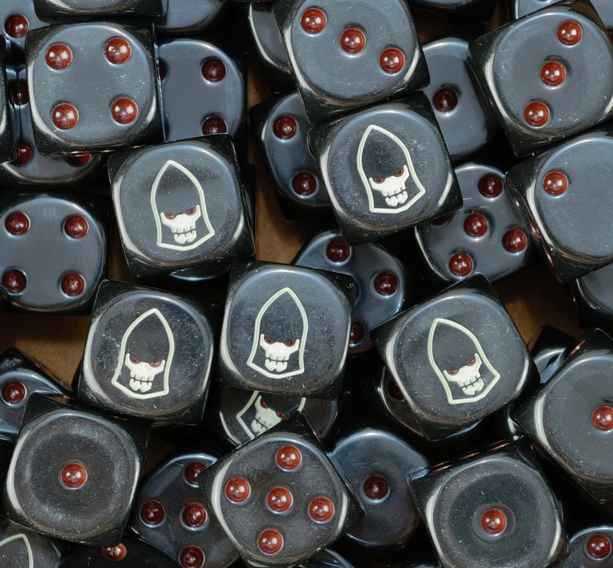 A pile of black Dark Reapers dice with red pips and pale white helms