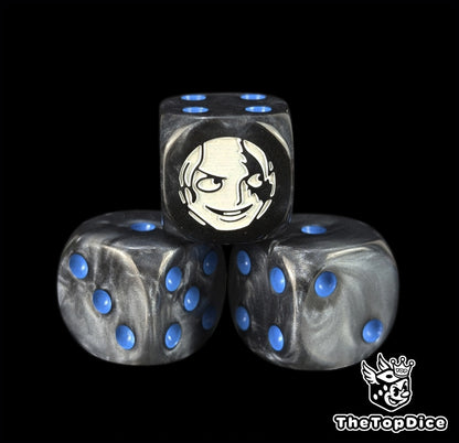 Close up of a black 16mm resin D6 die engraved with a white fighter emblem and blue pips