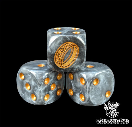 Close up of a black semi clear 16mm resin D6 die engraved with a gold ring and gold pips