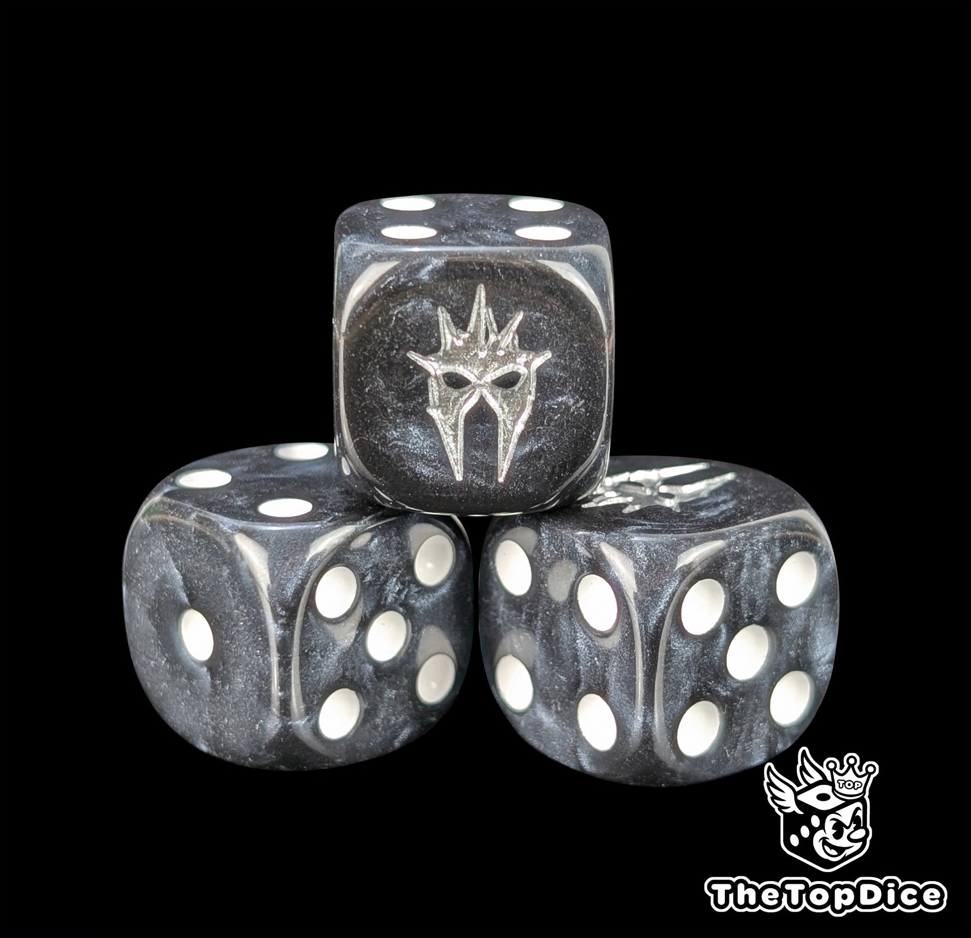 Close up of a black 16mm resin D6 die engraved with a silver wraith helm and white pips