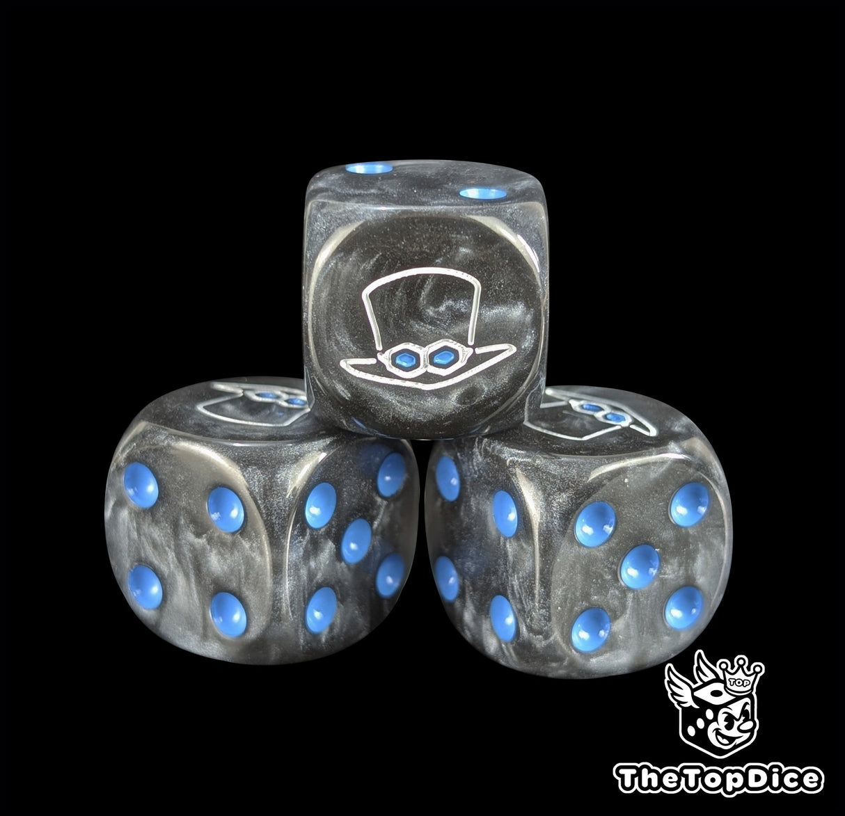 Close up of a black 16mm resin D6 die engraved with a white top hat emblem and blue pips