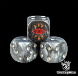Close up of a black 16mm resin D6 die engraved with a red eye ringed in gold chaos spikes