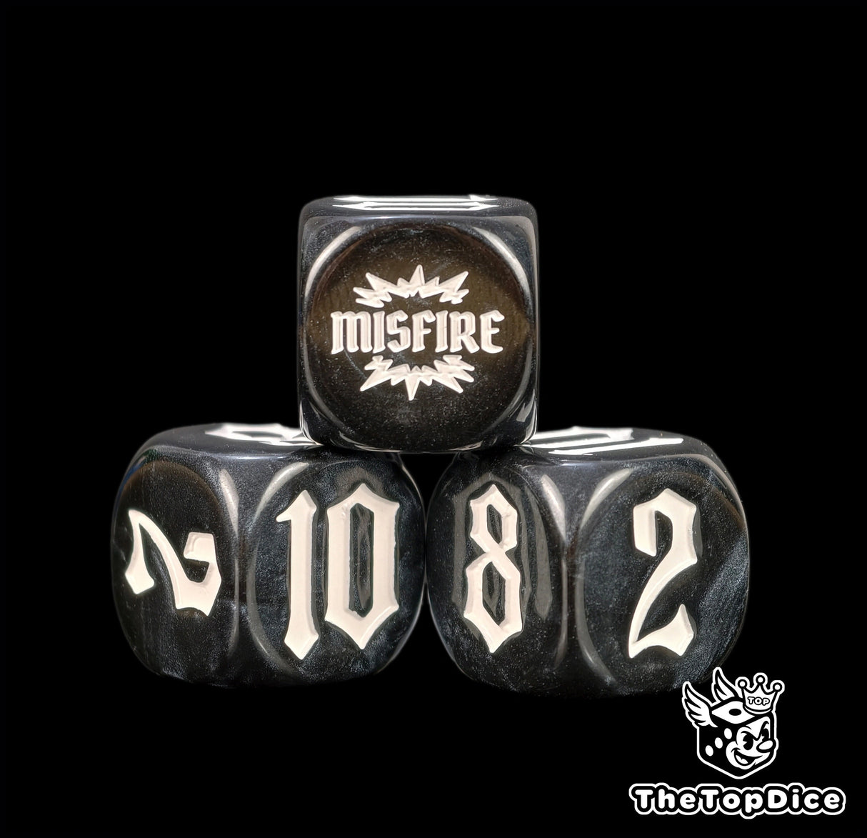 Black resin at close range, four 16mm dice whose white numerals hold their edge