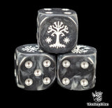 Close up of a black and grey 16mm resin D6 die engraved with a white tree and silver pips