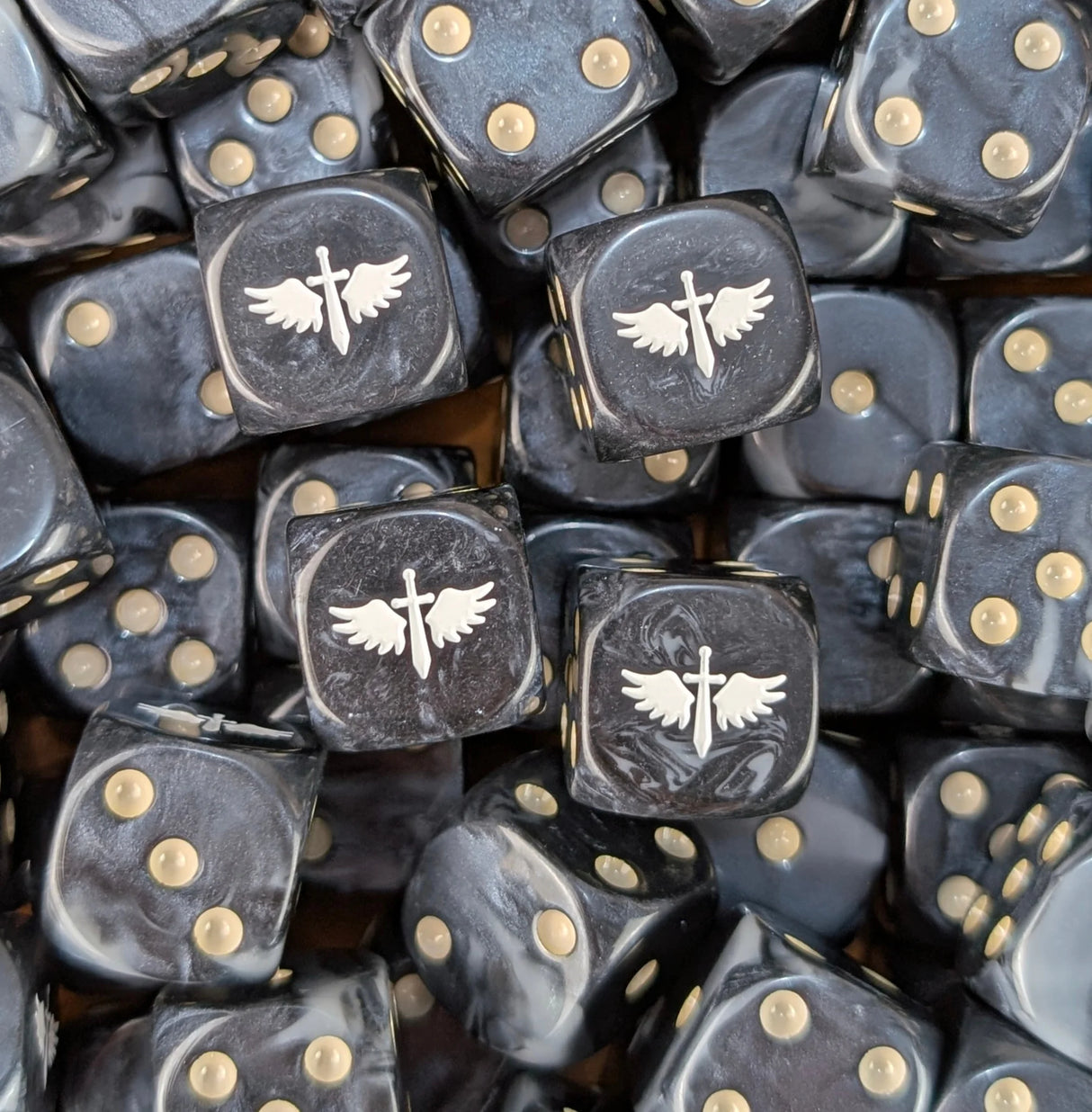 Pile of black and grey winged sword 16mm D6 dice for a sci-fi fast army