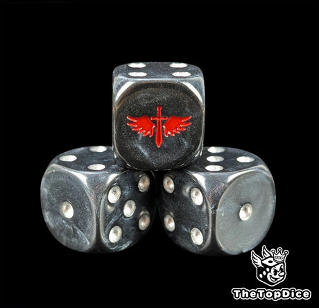 Close up of a black 16mm resin D6 die engraved with a red winged sword and silver pips