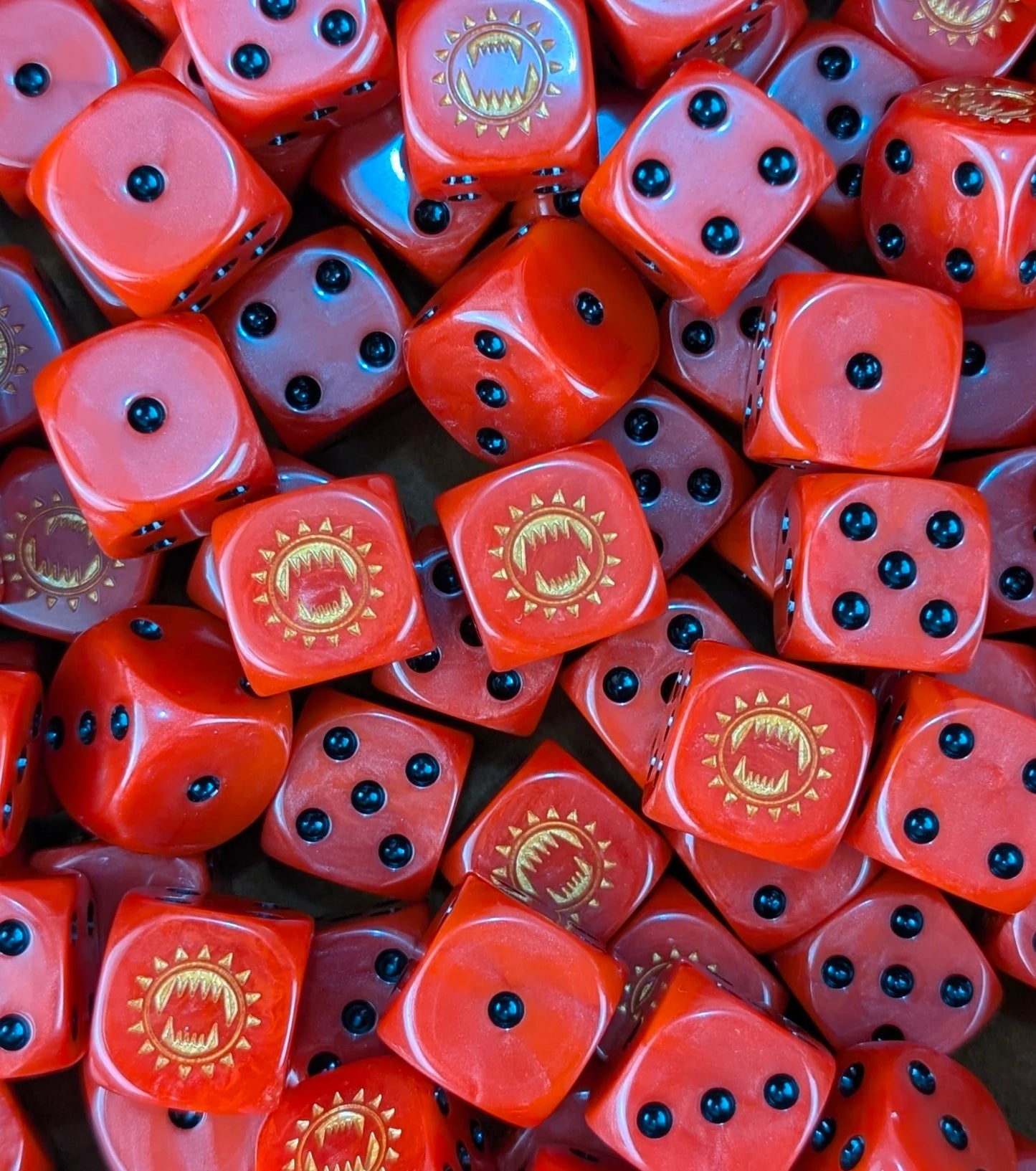 Pile of red 16mm D6 dice with gold maw emblems for a sci-fi berserker army