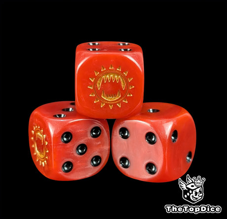 Close up of a red 16mm resin D6 die engraved with a gold toothed maw and black pips