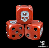 Close up of a red 16mm resin D6 die engraved with a bone white skull rune and black pips