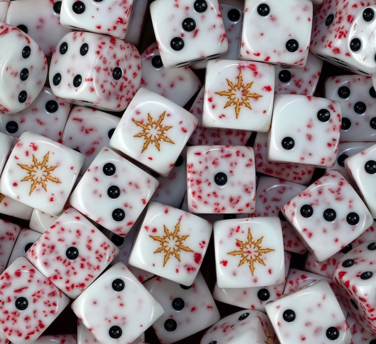 A pile of blood speckled white chaos D6 with gold eight pointed stars