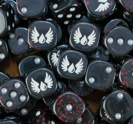 Pile of black blood splatter dice with white winged blood drops and silver pips for a Blood Angels army