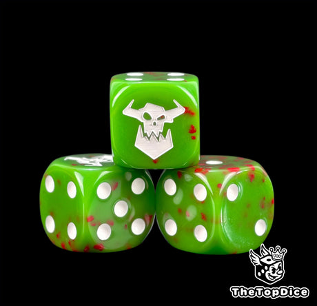 Three green greenskin Ork dice spattered with red and a white orc skull