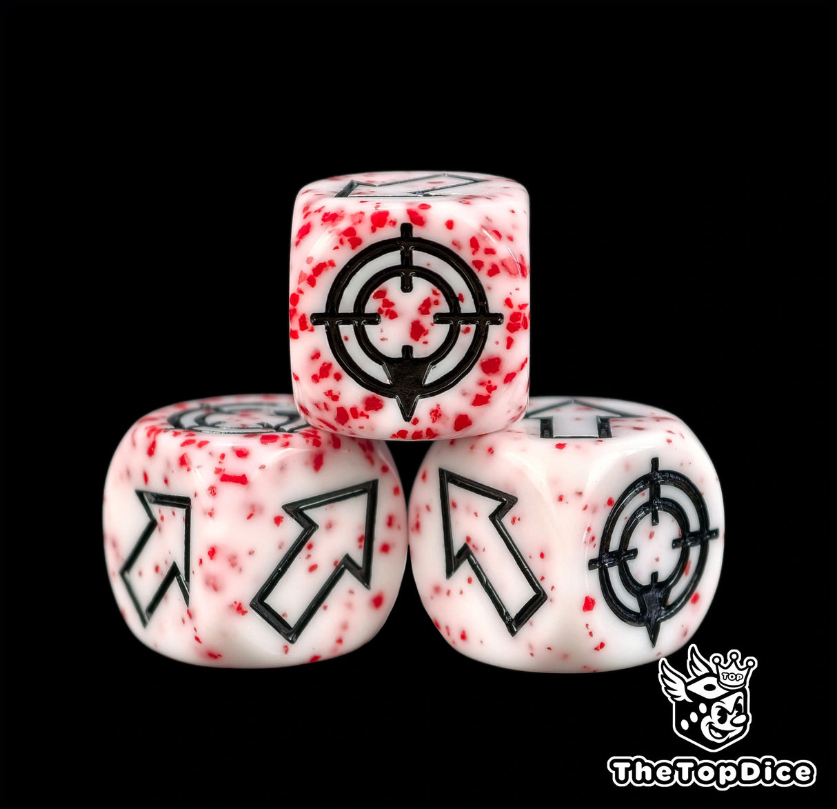 Close look at three bloodspatter dice, every casting flecked differently under the black arrows