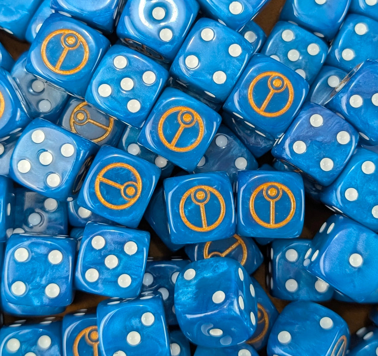Pile of blue cadre sigil 16mm D6 dice for a sci-fi xeno army
