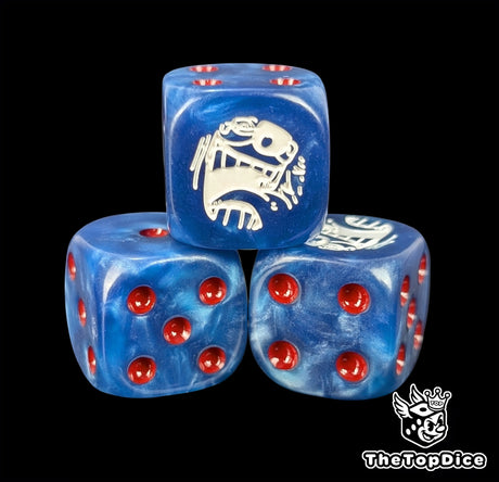 Close up of a blue 16mm resin D6 die engraved with a white clown emblem and red pips