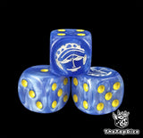 Close up of a blue 16mm resin D6 die engraved with a white surgeon emblem and yellow pips
