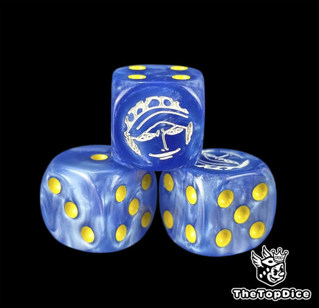 Close up of a blue 16mm resin D6 die engraved with a white surgeon emblem and yellow pips
