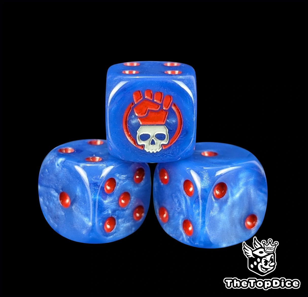 Close up of a blue 16mm resin D6 die engraved with a red fist over a grey skull and red pips