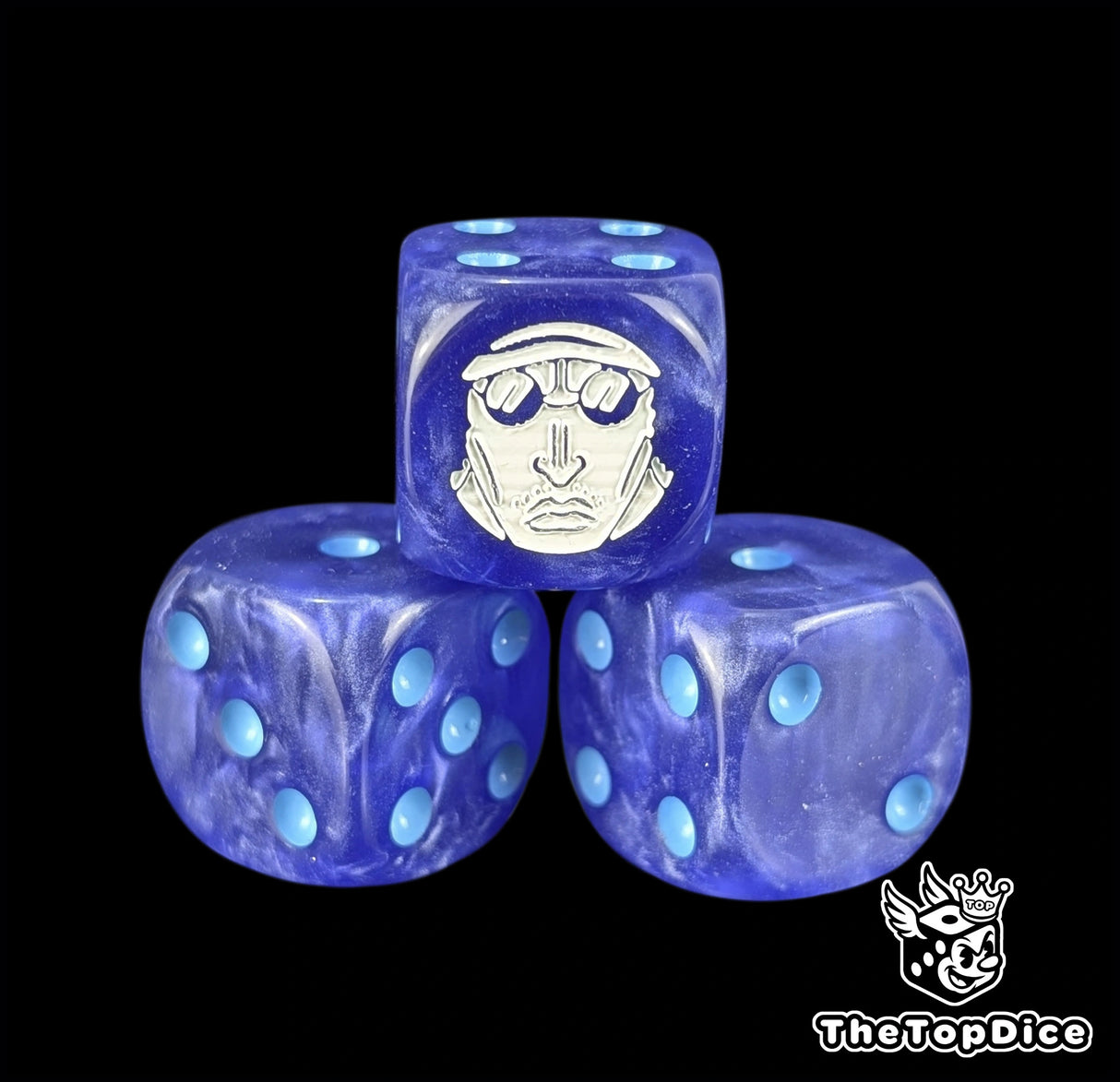 Close up of a dark navy 16mm resin D6 die engraved with a white admiral emblem and ice blue pips