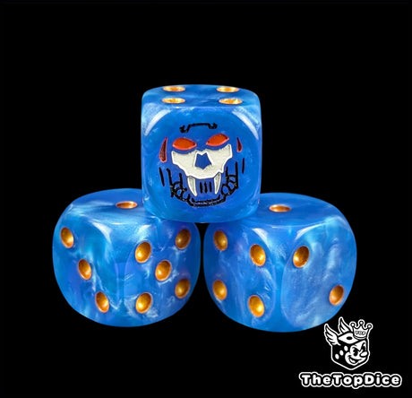 Close up of a blue 16mm resin D6 die engraved with a black fanged helm face and gold pips