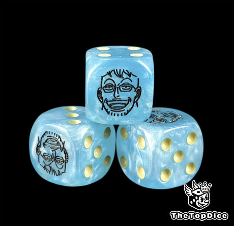 Close up of a blue 16mm resin D6 die engraved with a black phoenix emblem and yellow pips