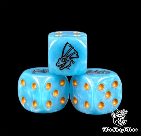Three blue lizardmen dice with amber pips and a saurian emblem