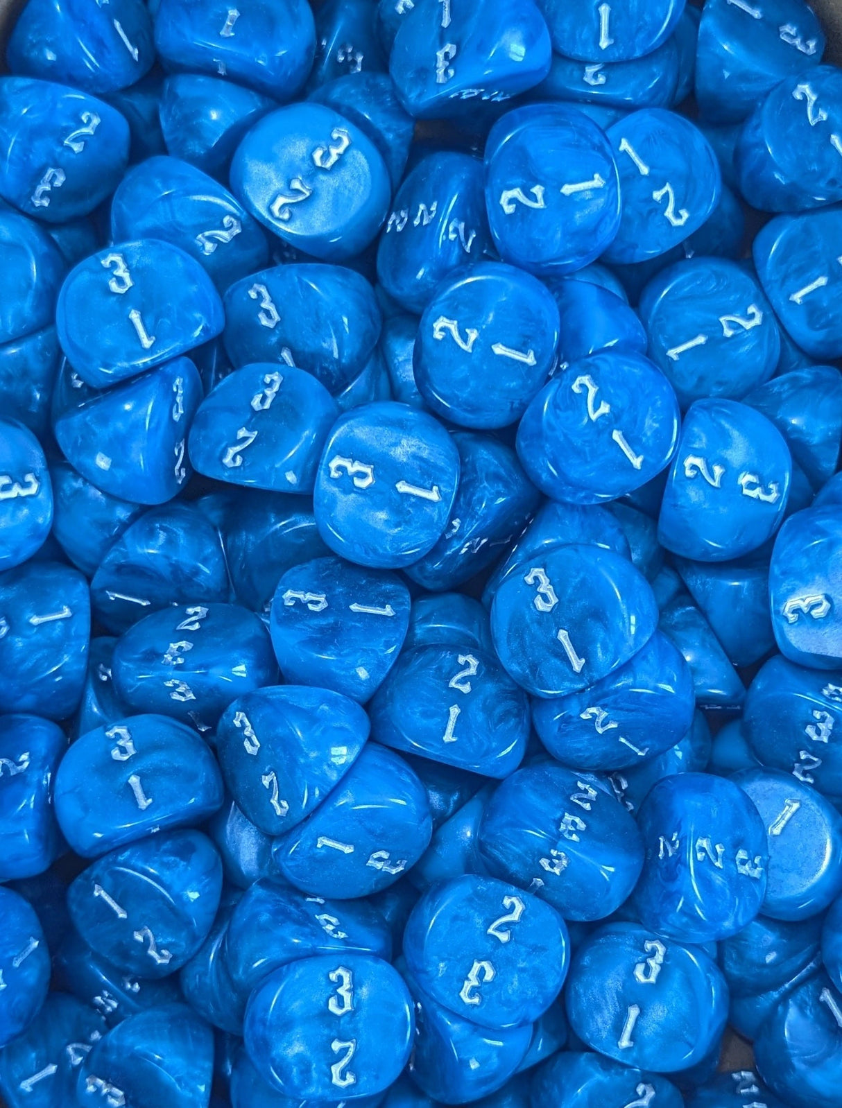 Pile of blue D3 three sided dice for tabletop games