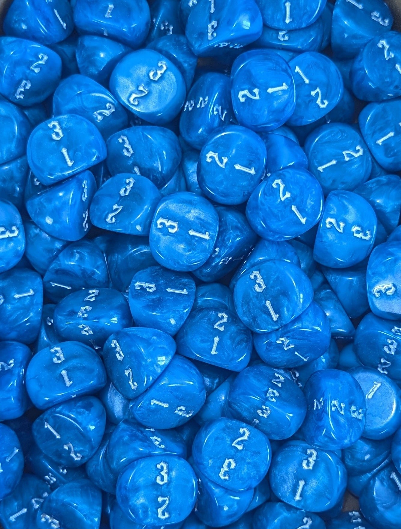 Pile of blue D3 three sided dice for tabletop games