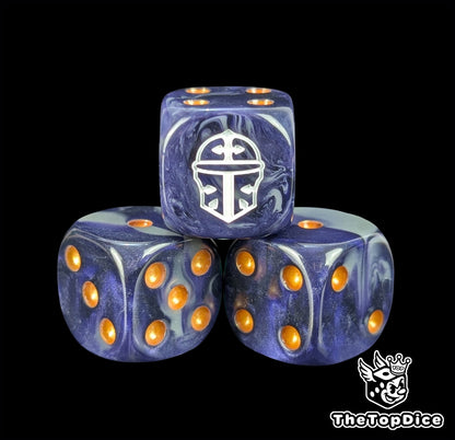 Close up of a blue and grey 16mm resin D6 die engraved with a white war helm and gold pips