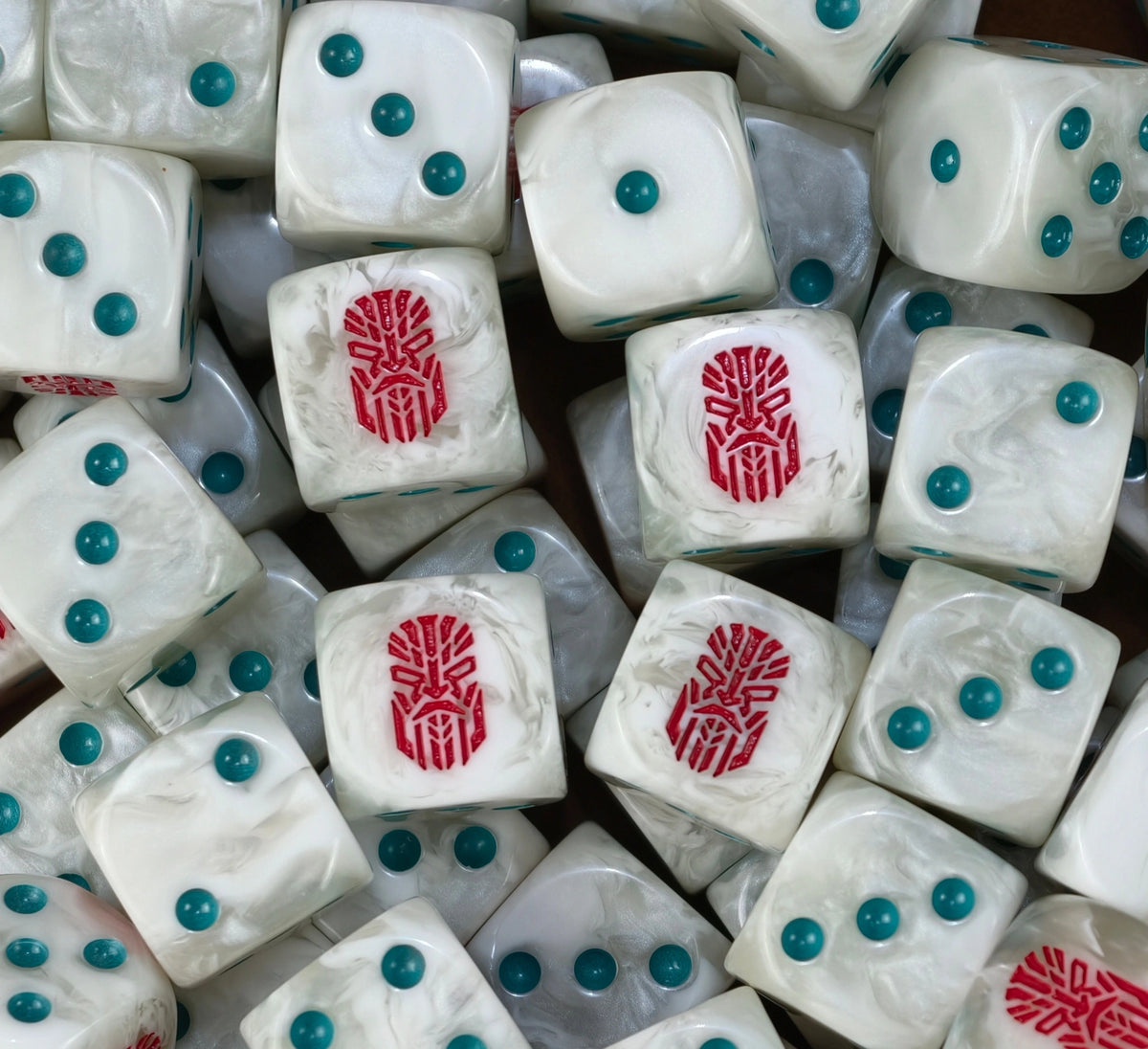 A pile of bone white Votann D6 with teal pips and red kin runes