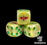 Close up of a bone white 16mm resin D6 die engraved with a red winged sword and green pips