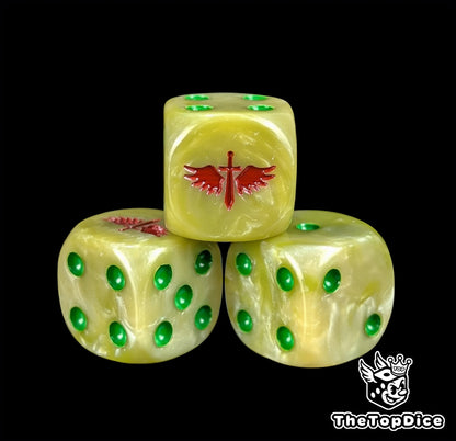 Close up of a bone white 16mm resin D6 die engraved with a red winged sword and green pips