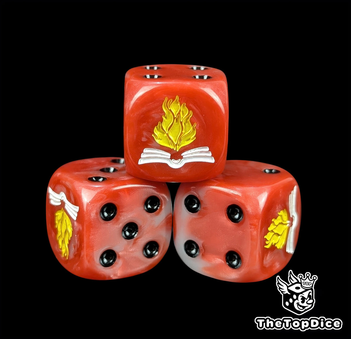 Close-up of a red D6 die with an open white tome and yellow flame