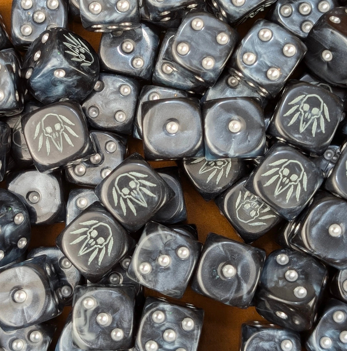 Pile of black raven skull 16mm D6 dice ready for a fantasy carrion army